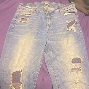 Blue jeans with plaid hole covering. Size15